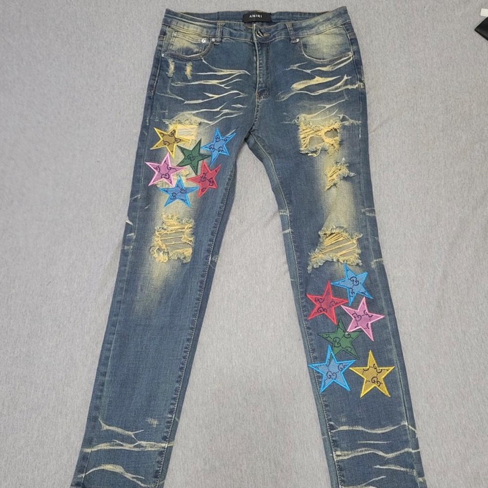 AMIRI Distressed Blue Denim Jeans with Multicolor Star Patches